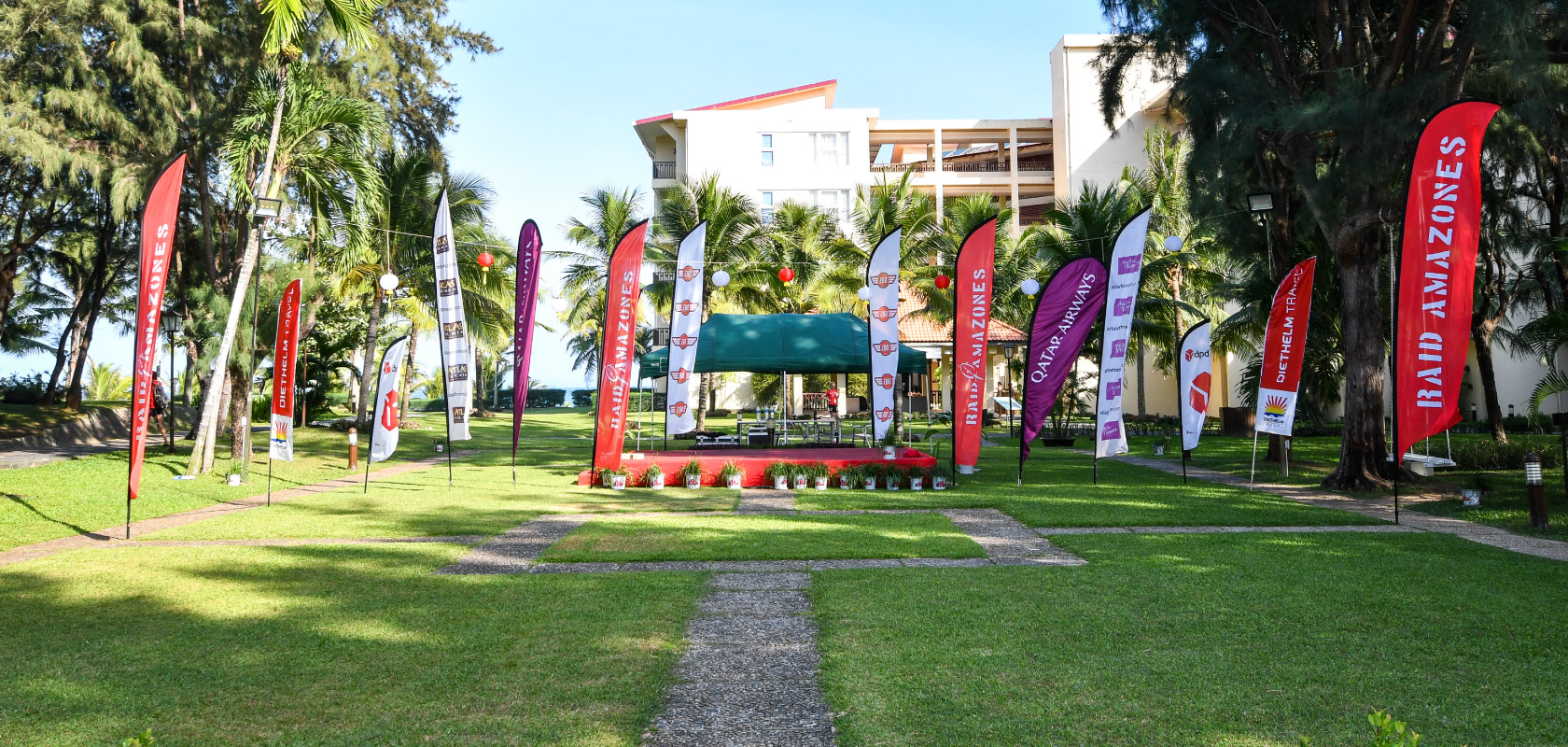 A photo of Diethelm Travel flags in the yard.